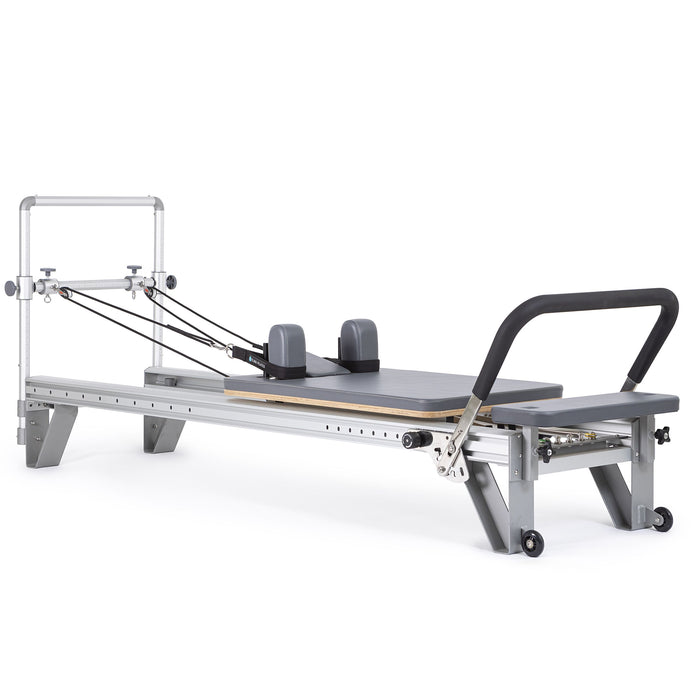 Elina Pilates Mentor Reformer Bundle with grey upholstery and its integrated mini tower, angled view