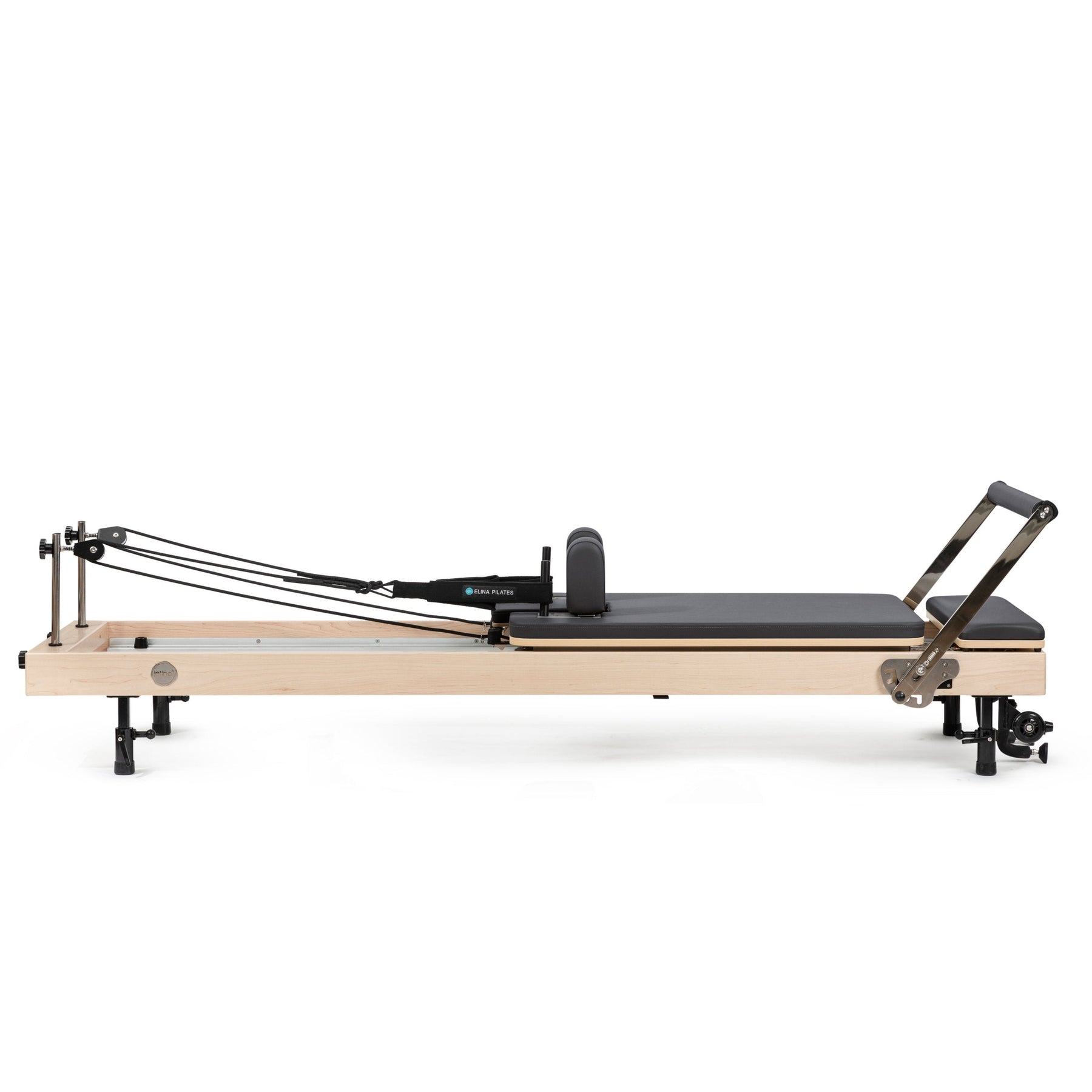 Elina Pilates Vertical Reformer in light maple, a home reformer that stands upright on removable legs for storage