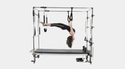 Align Pilates C8-Pro with Full Cadillac, user working in the trapeze straps