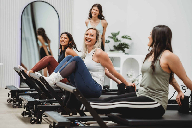 Align Pilates C8-Pro Noir, clients laughing during a group class