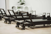 Align Pilates C8-Pro Noir, row of black reformers