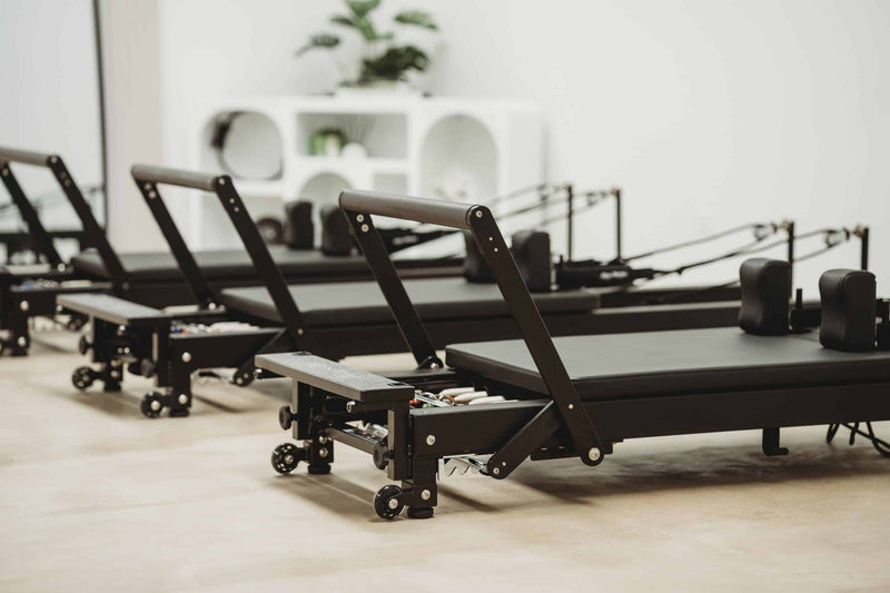 Align Pilates C8-Pro Noir, row of black reformers