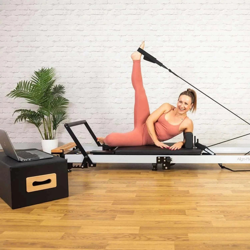 Align Pilates F3 Folding Reformer, woman doing a side lying leg exercise