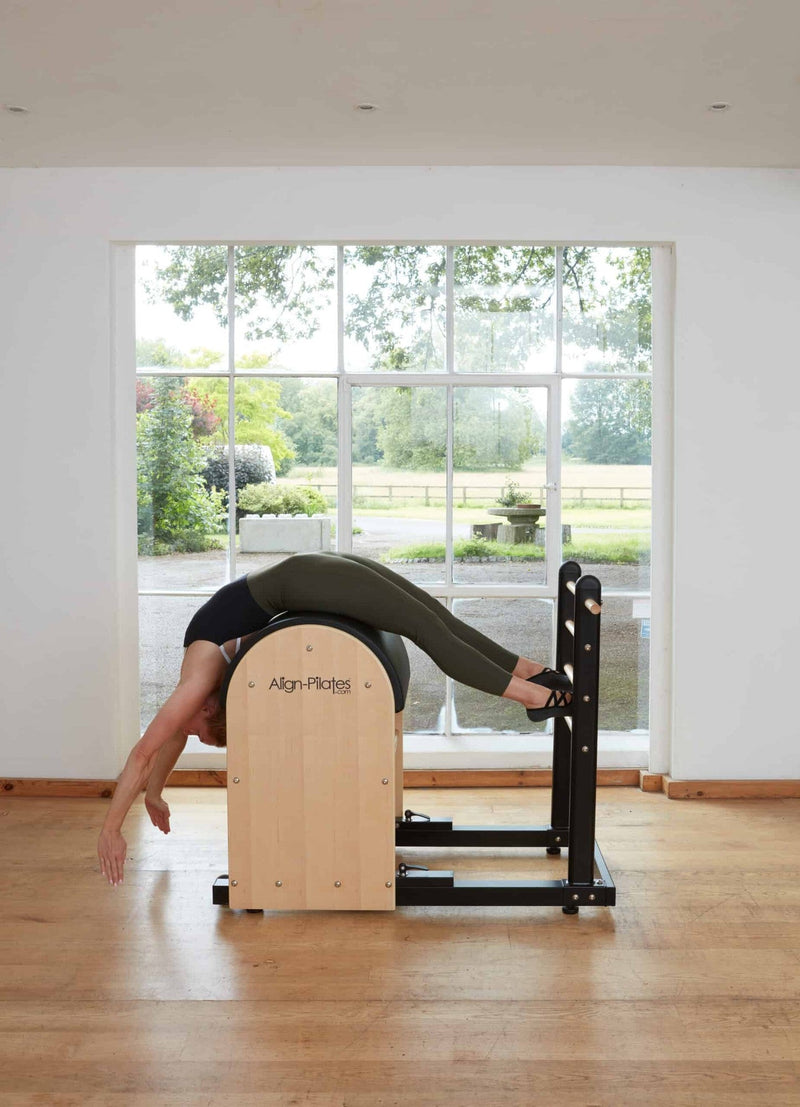 Align Pilates Ladder Barrel RC, woman in a back extension over the barrel