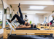 Align Pilates M8-Pro, client working with foot straps during a class