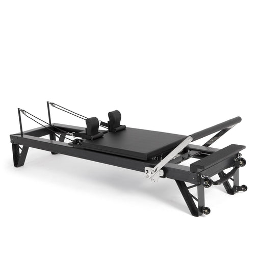 Elina Pilates HL 3 Aluminium Reformer with taller legs, black anodised frame, angled studio view