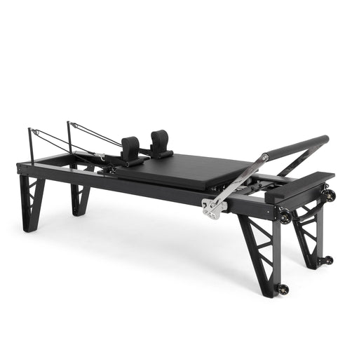 Elina Pilates HL 4 Aluminium Reformer with the tallest legs, black anodised frame, angled studio view