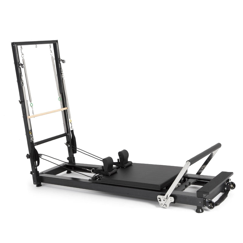 Elina Pilates HL 1 Aluminium Reformer with Tower, wooden push-through bar, angled studio view