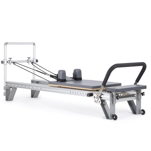 Elina Pilates Mentor Reformer in grey, angled studio view with mini tower