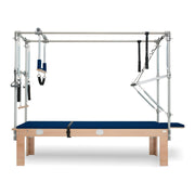 BASI Systems Cadillac Trapeze Table upholstered in Dark Navy, the whole apparatus shown against a plain background, second view