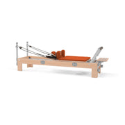 BASI Systems Compact Reformer upholstered in Campfire Orange, the whole apparatus shown against a plain background