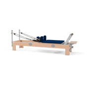 BASI Systems Compact Reformer upholstered in Dark Navy, the whole apparatus shown against a plain background