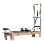 BASI Systems Compact Reformer with Tower upholstered in Dark Cool Sand, the whole apparatus shown against a plain background