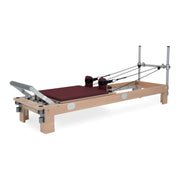 BASI Systems Reformer upholstered in Burgundy, the whole apparatus shown against a plain background