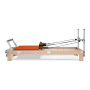 BASI Systems Reformer upholstered in Campfire Orange, the whole apparatus shown against a plain background