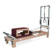 BASI Systems Reformer with Tower upholstered in Burgundy, the whole apparatus shown against a plain background, second view