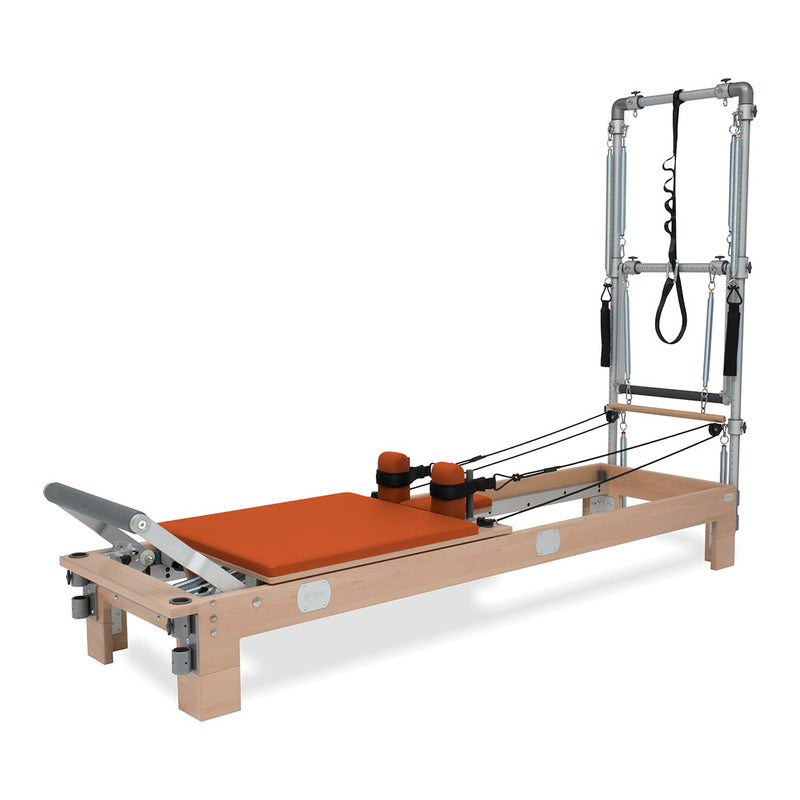BASI Systems Reformer with Tower upholstered in Campfire Orange, the whole apparatus shown against a plain background