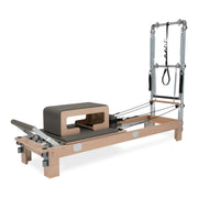 BASI Systems Reformer with Tower upholstered in Dark Cool Sand, the whole apparatus shown against a plain background, second view