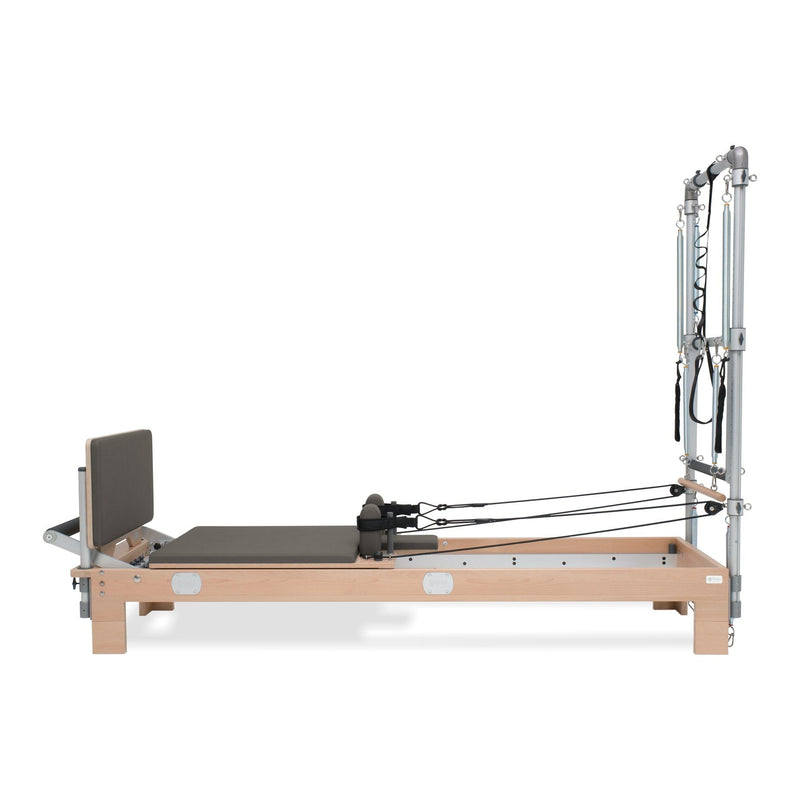 BASI Systems Reformer with Tower upholstered in Dark Cool Sand, the whole apparatus shown against a plain background, third view