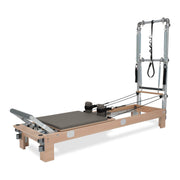 BASI Systems Reformer with Tower upholstered in Dark Cool Sand, the whole apparatus shown against a plain background