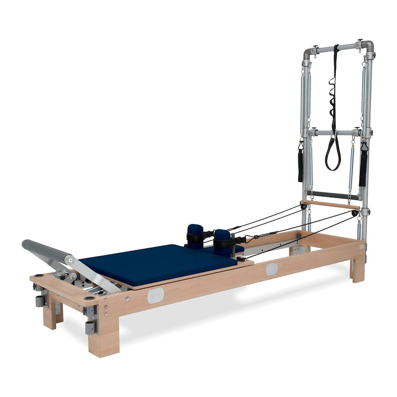 BASI Systems Reformer with Tower upholstered in Dark Navy, the whole apparatus shown against a plain background