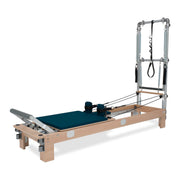 BASI Systems Reformer with Tower upholstered in Petrol Green, the whole apparatus shown against a plain background