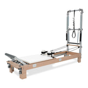 BASI Systems Reformer with Tower upholstered in Pristine White, the whole apparatus shown against a plain background