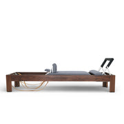 Classic Dark Wood Reformer side view, grey upholstery, walnut frame