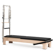 Elite Advanced Reformer with Tower in black, ropes and shoulder rests visible