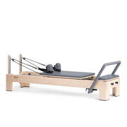 Elina Pilates Elite Advanced Reformer in grey, angled studio view with rope risers