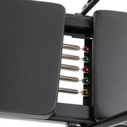 Five color-coded springs between the carriage pads