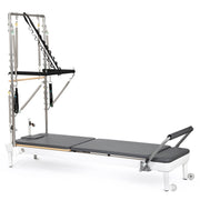 Nubium Reformer with Tower, white frame with grey upholstery, angled studio view