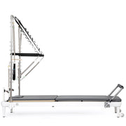 Nubium Reformer with Tower side view, grey upholstery