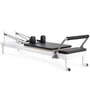 Elina Pilates Nubium Reformer, white frame with black upholstery, angled studio view