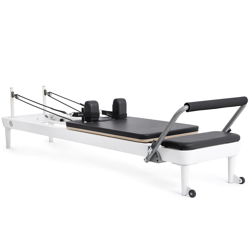 Elina Pilates Nubium Reformer, white frame with black upholstery, angled studio view