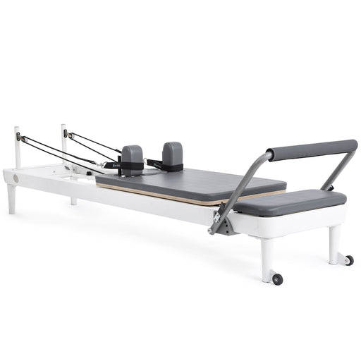 Elina Pilates Nubium Reformer, white aluminum frame with grey upholstery, angled studio view