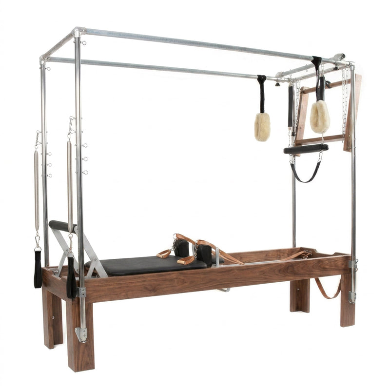 Peak Pilates Artistry Convertible with Leather Straps in walnut, angled studio view