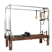 Peak Pilates Artistry Convertible with Rope in walnut, angled studio view