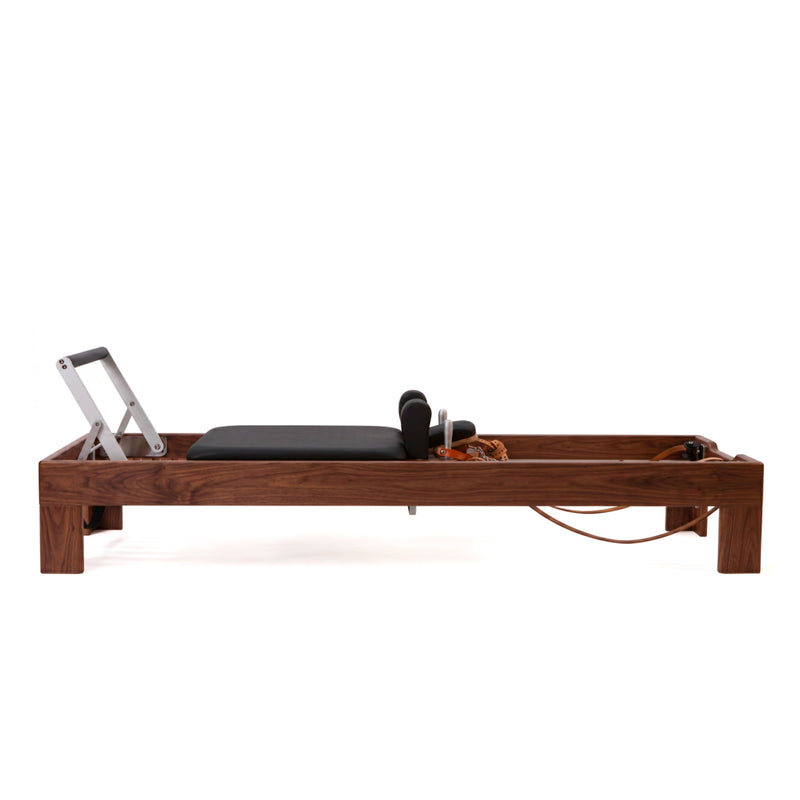 Peak Pilates Artistry Reformer with Leather in walnut, side view
