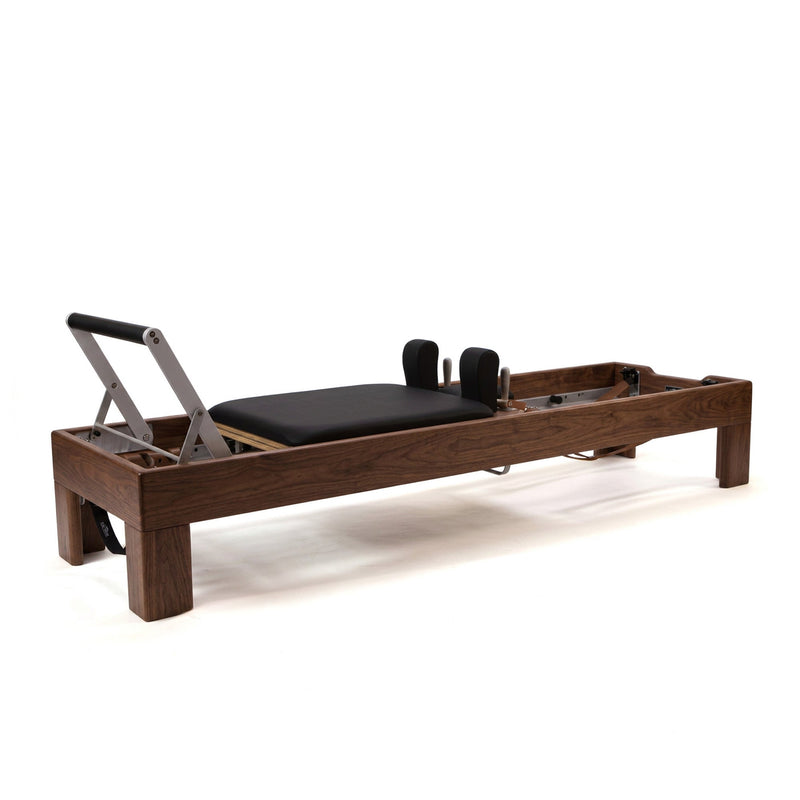 Peak Pilates Artistry Reformer with Leather in walnut, studio view