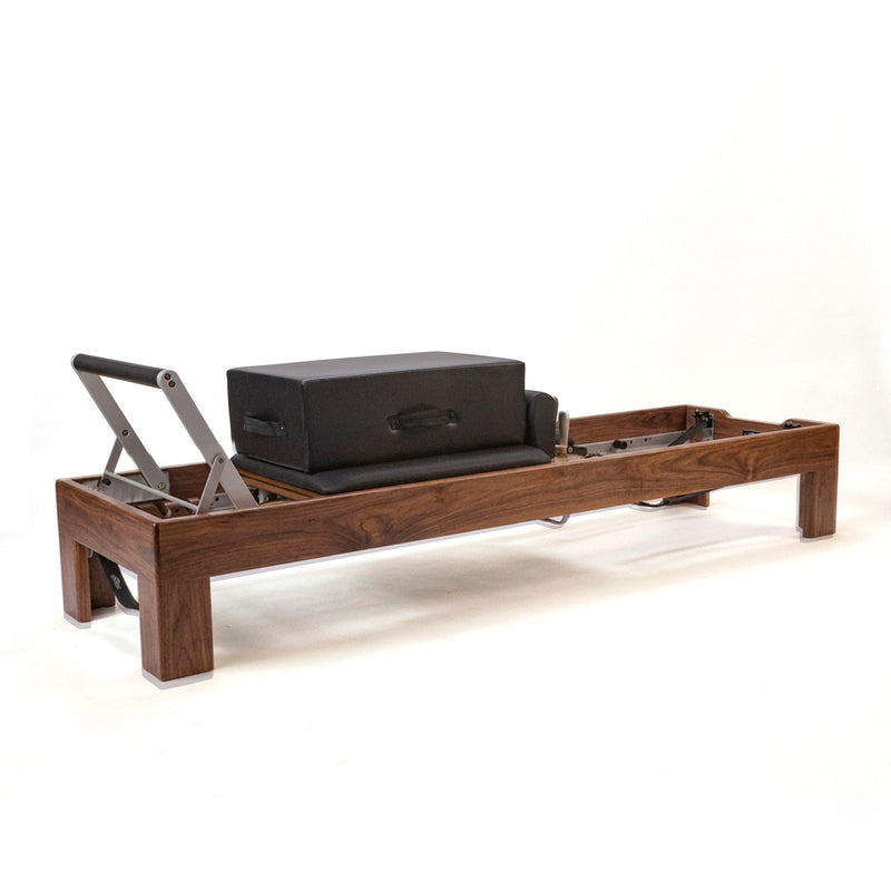 Peak Pilates Artistry Reformer with Vegan Straps in walnut, studio view