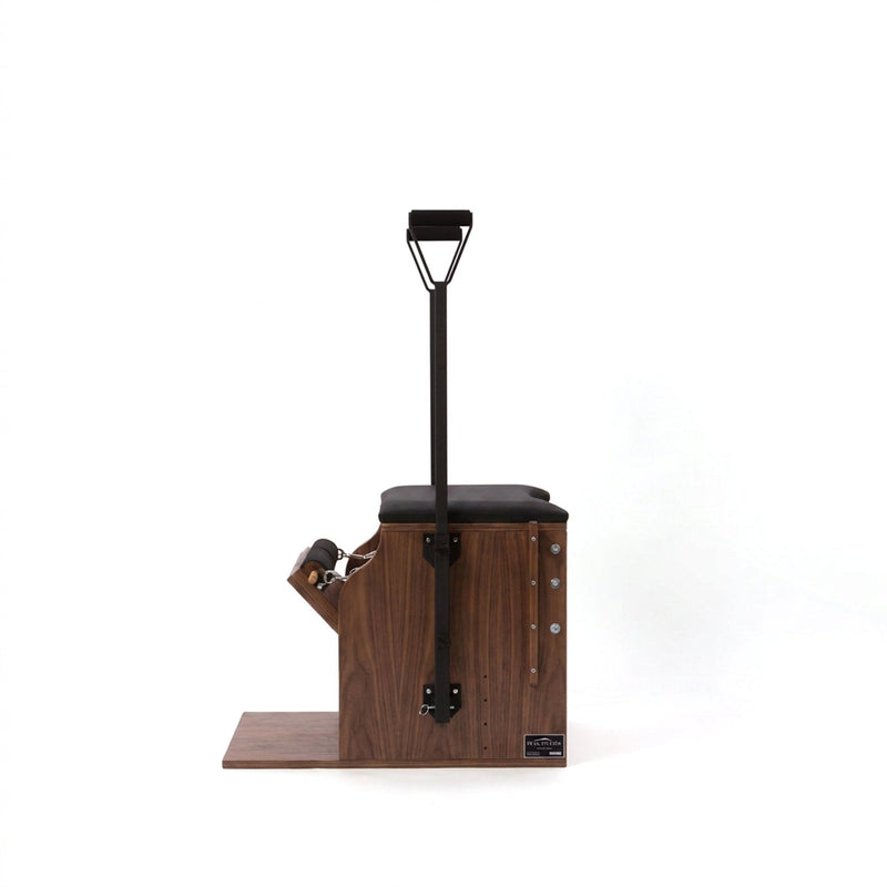 Peak Pilates Artistry Split Pedal Low Chair with Handles & Brackets in walnut, studio view