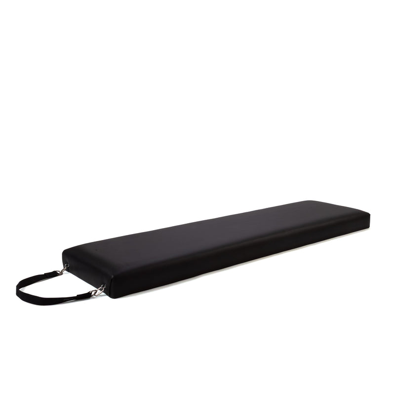 Peak Pilates Raised Platform Mat in black, angled view showing the padded surface and end carry strap