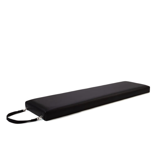 Peak Pilates Raised Platform Mat in black, angled view showing the padded surface and end carry strap
