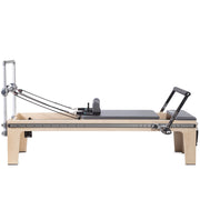 Master Instructor Physio Reformer side view showing the raised bed, grey