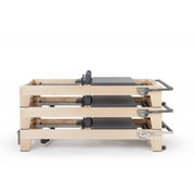 Three Elite Wood Reformers stacked, grey upholstery