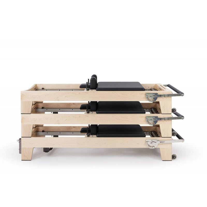 Three Elite Wood Reformers stacked, black upholstery