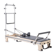 Master Instructor Reformer with Tower in grey, angled studio view