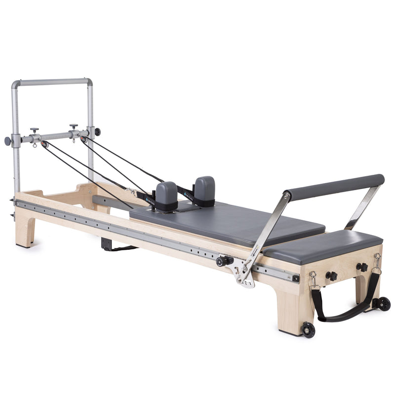 Elina Pilates Master Instructor Reformer in grey, angled studio view with mini tower