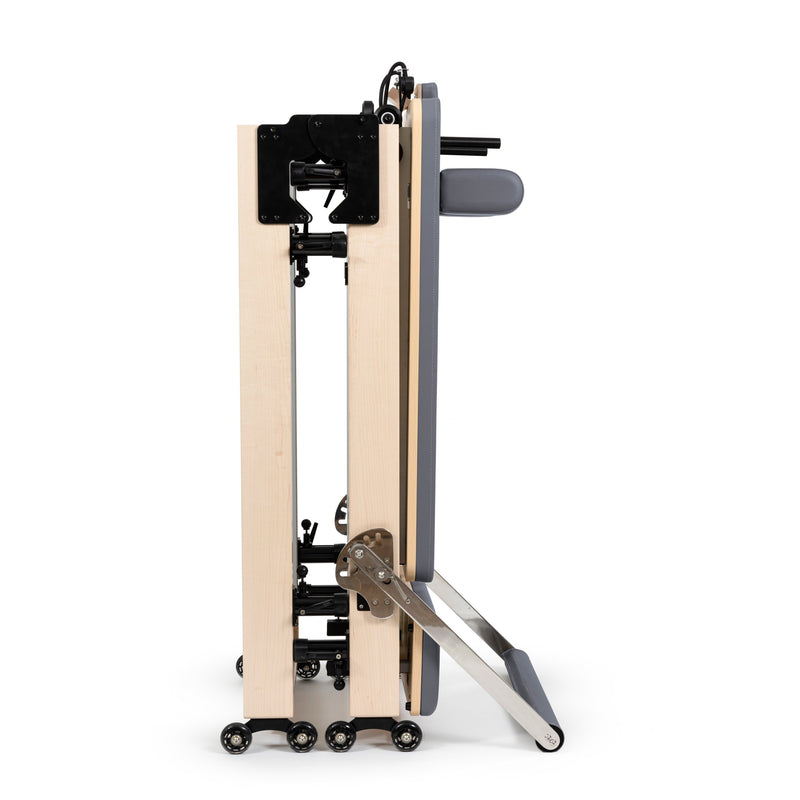 Fold Reformer folded in half and standing on its wheels, grey - the folded storage position